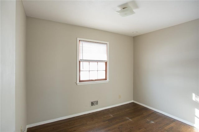 spare room featuring dark wood-type flooring