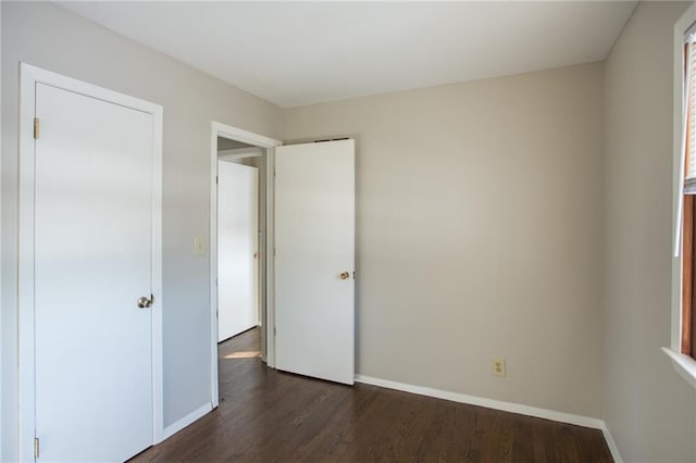 unfurnished bedroom featuring dark hardwood / wood-style flooring