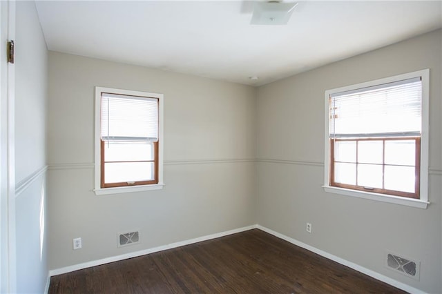 spare room with dark hardwood / wood-style flooring