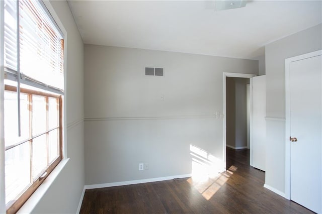 unfurnished room featuring dark hardwood / wood-style floors