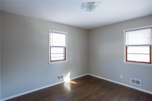 empty room with dark hardwood / wood-style floors