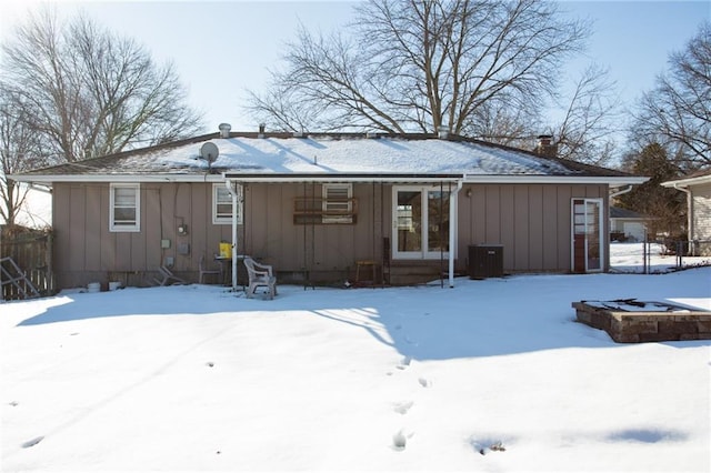 snow covered house with cooling unit