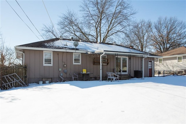 snow covered property featuring central air condition unit