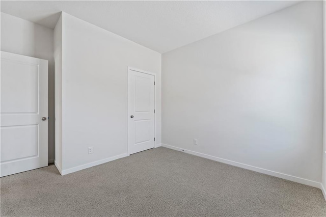 unfurnished room featuring light colored carpet