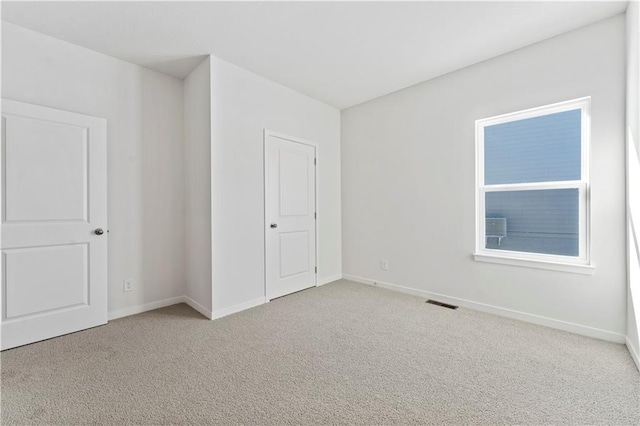 unfurnished bedroom featuring light carpet