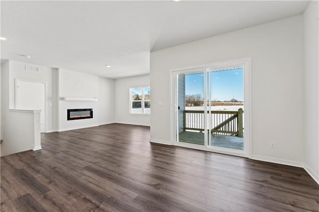 unfurnished living room featuring dark hardwood / wood-style floors