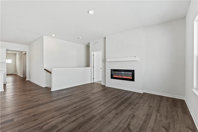 unfurnished living room with dark wood-type flooring