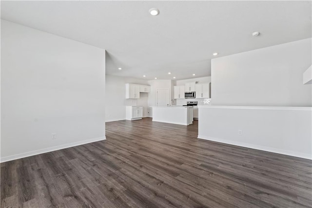 unfurnished living room featuring dark wood-type flooring