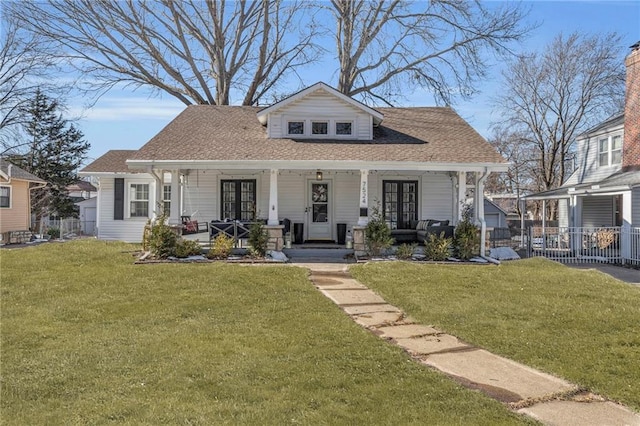 bungalow-style home with a front yard and covered porch