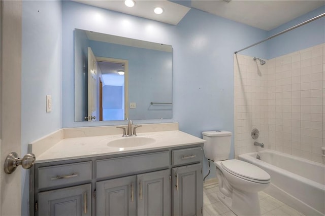 full bathroom featuring tile patterned floors, tiled shower / bath combo, vanity, and toilet