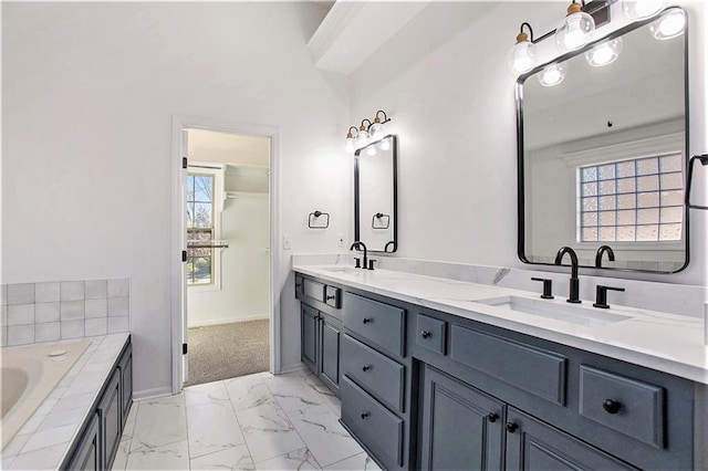 bathroom featuring vanity and a bath