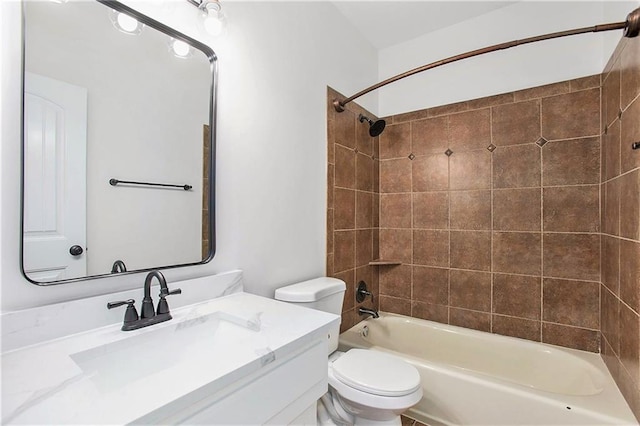 full bathroom featuring tiled shower / bath combo, vanity, and toilet