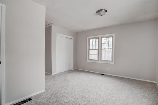 unfurnished room with light carpet