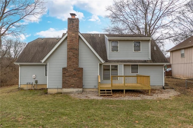 back of house featuring a wooden deck and a lawn