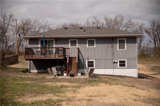 back of house with a fire pit, a deck, a yard, a patio, and stairs