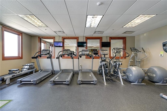 gym with a paneled ceiling