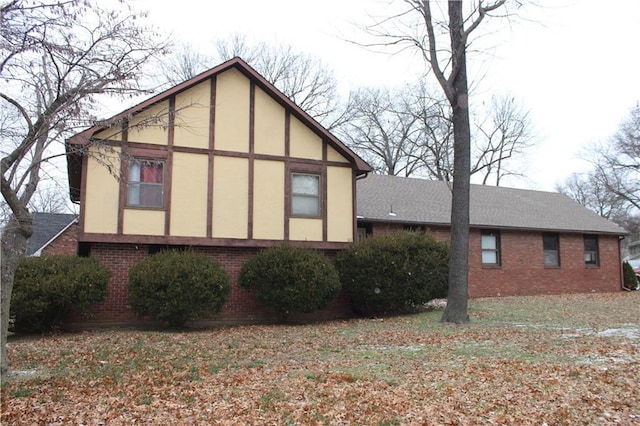 view of side of property with a lawn