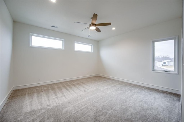 carpeted spare room with ceiling fan