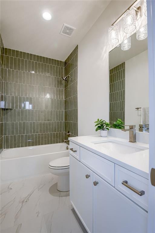 full bathroom featuring vanity, toilet, and tiled shower / bath