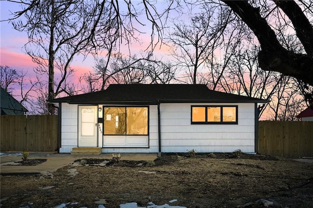 view of back house at dusk