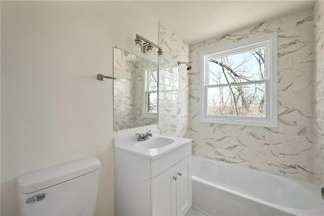 bathroom featuring vanity, a washtub, and toilet