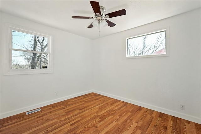 empty room featuring hardwood / wood-style flooring and ceiling fan