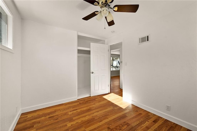 unfurnished bedroom featuring wood-type flooring, a closet, and ceiling fan