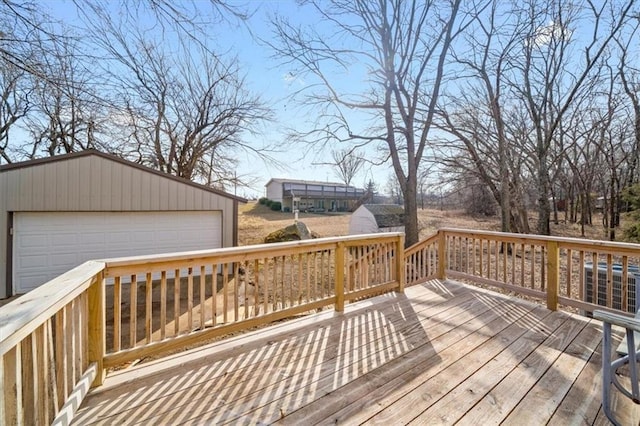 deck featuring a garage and an outdoor structure