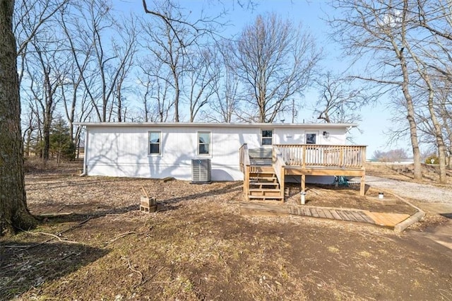 back of property featuring a wooden deck and cooling unit