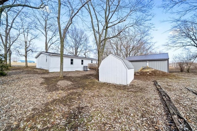 view of yard with a storage shed and central AC unit