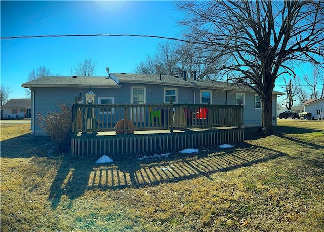 rear view of house with a yard and a deck