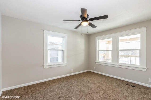 carpeted spare room with ceiling fan