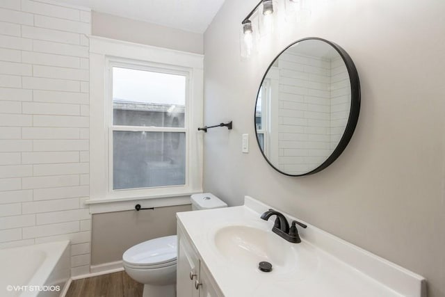 bathroom featuring wood-type flooring, toilet, and vanity