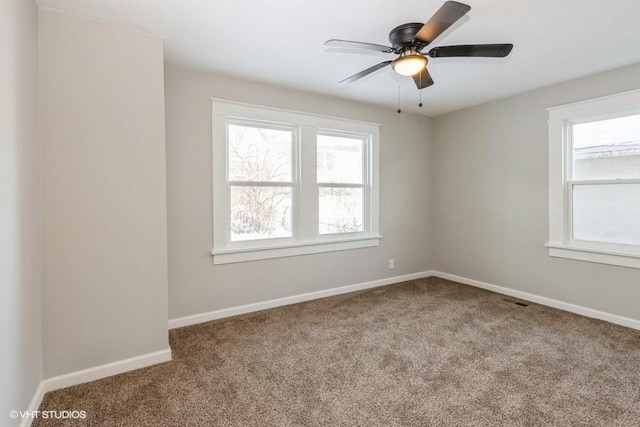 empty room with ceiling fan and light colored carpet