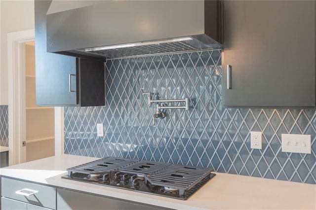 kitchen featuring range hood and black gas cooktop