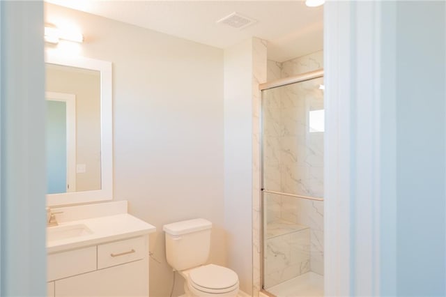 bathroom featuring walk in shower, vanity, and toilet