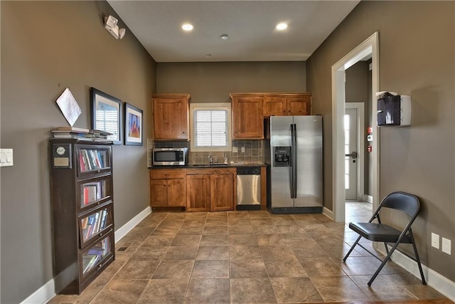 kitchen featuring decorative backsplash, sink, and stainless steel appliances