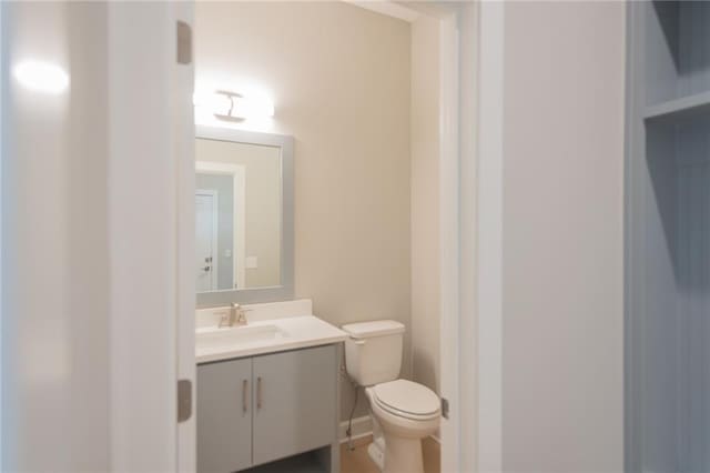 half bathroom with toilet and vanity