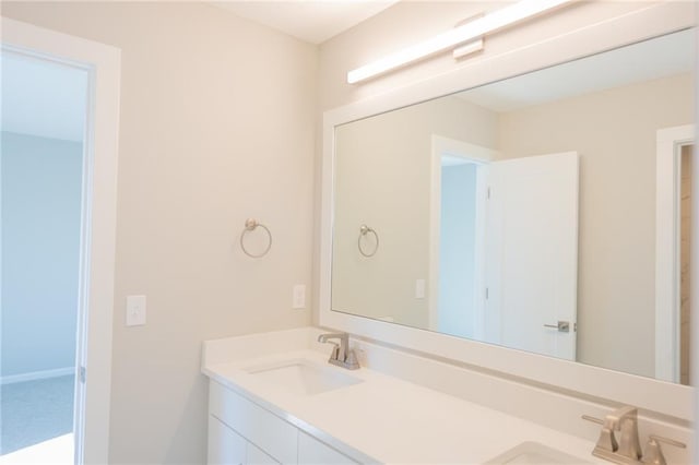 bathroom with a sink and double vanity