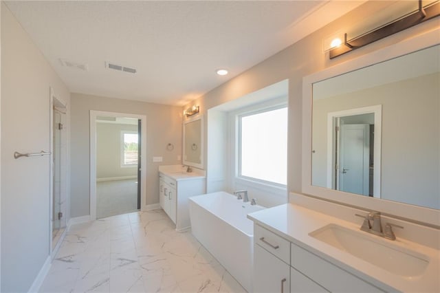 full bathroom with visible vents, a soaking tub, a sink, marble finish floor, and two vanities