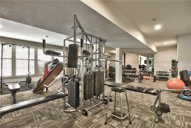 gym featuring carpet floors and a textured ceiling