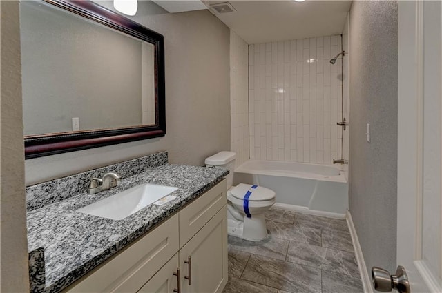 full bathroom featuring toilet, tiled shower / bath combo, and vanity