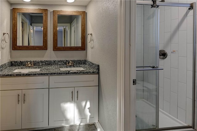 bathroom featuring vanity and a shower with door