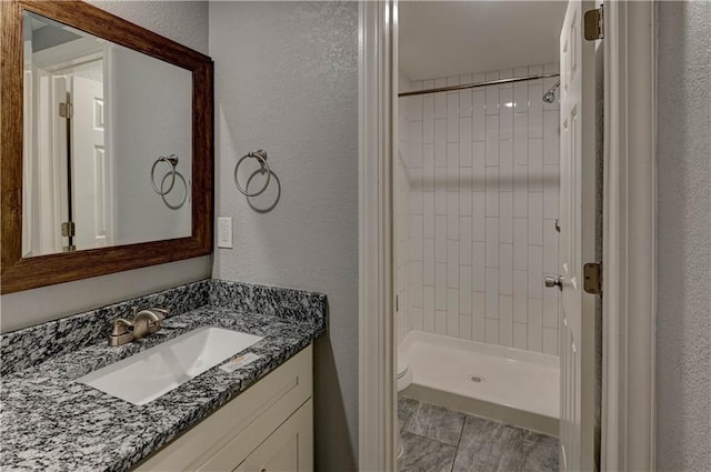 bathroom featuring vanity and a tile shower