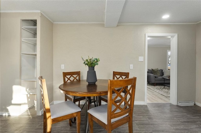 dining space featuring hardwood / wood-style floors and ornamental molding