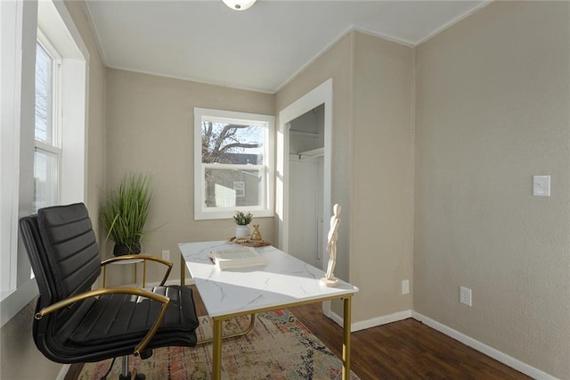 office with crown molding and dark wood-type flooring