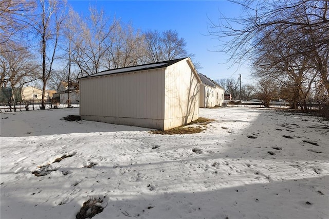 view of snowy exterior featuring an outdoor structure