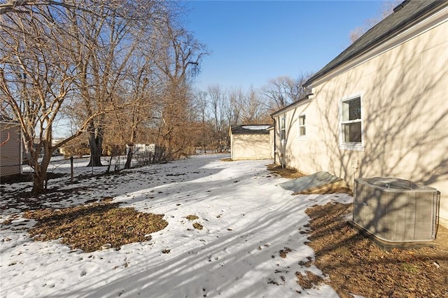 snowy yard featuring cooling unit