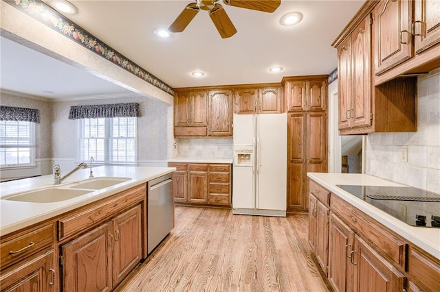 kitchen featuring black electric stovetop, light hardwood / wood-style floors, stainless steel dishwasher, sink, and white refrigerator with ice dispenser