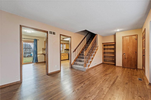 interior space with hardwood / wood-style floors and a textured ceiling